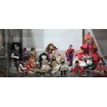 One shelf of international dolls, including Japanese, Polish, Italian, etc. Largest 17.5"h