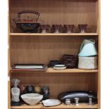 Three shelves of Asian style art pottery including tea cups and saucers, and a tea pot, together