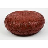 Chinese cinnabar-style circular covered box, the lid decorated with scholars in a garden terrace,