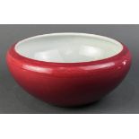 Chinese glazed porcelain brush washer, of a rose red hue, with wide shoulders and sharply tapering