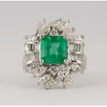 Emerald, diamond and 18k white gold ring Centering (1) emerald-cut emerald, weighing 2.72 cts.,