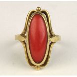 Coral and 18k yellow gold ring Featuring (1) oval coral cabochon, measuring approximately 19 X 7 X 4