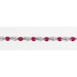 Ruby, diamond and 18k white gold bracelet Featuring (10) oval-cut rubies, weighing a total of