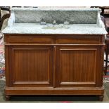 Edwardian vanity, having a green and white marble top, with an inset oval sink, above the mahogany