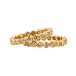 (Lot of 2) Diamond and 18k yellow gold eternity bands Each featuring (20) full-cut diamonds,