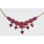 Ruby and 18k yellow gold necklace Featuring (74) oval-cut rubies, weighing a total of