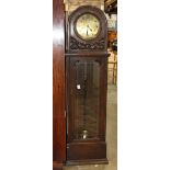 Art Deco tall case clock, having a brass dial with Arabic markers housed in an oak case, with