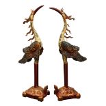 Pair of Vietnamese polychrome wood cranes, each with a white head and body accented by gilt wings,