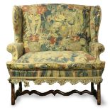 French Provincial wing back settee, 18th century, having needlepoint tapestry upholstery and