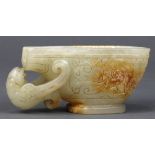 Chinese hardstone libation cup, with a stylized bird form handle, and the body of the vessel with