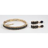 Sapphire and 9k yellow gold jewelry suite Including 1) bracelet, featuring (19) oval-cut