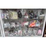 Six shelves of doll accessories, including Barbie kitchenware, vintage doll clothing, shoes, etc.