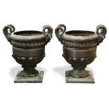 Pair of patinated bronze garden urns, each in the Neoclassical taste, having mythological mounts