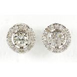 Pair of diamond and 18k white gold earrings Centering (2) round brilliant-cut diamonds, weighing a