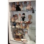 Four shelves of dolls, consisting of Kewpie style dolls, Madame Alexander, and a Sonia Messer Co.