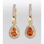 Pair of garnet, diamond and 14k yellow gold earrings Centering (2) pear-cut mandarin garnets,