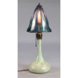 Tiffany style favrile glass table lamp, having a mushroom shade with an iridescent blue to green