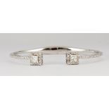 Diamond and 18k white gold bracelet Featuring (2) princess-cut diamonds, weighing a total of