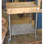 Modern Boos Block butcher block kitchen island, having a solid maple 5" top above the stainless