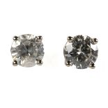 Pair of diamond and 14k white gold earrings Featuring (2) round brilliant-cut diamonds, weighing a