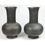 Pair of Middle Eastern silvered copper vases, each having a stick neck above a bulbous body,