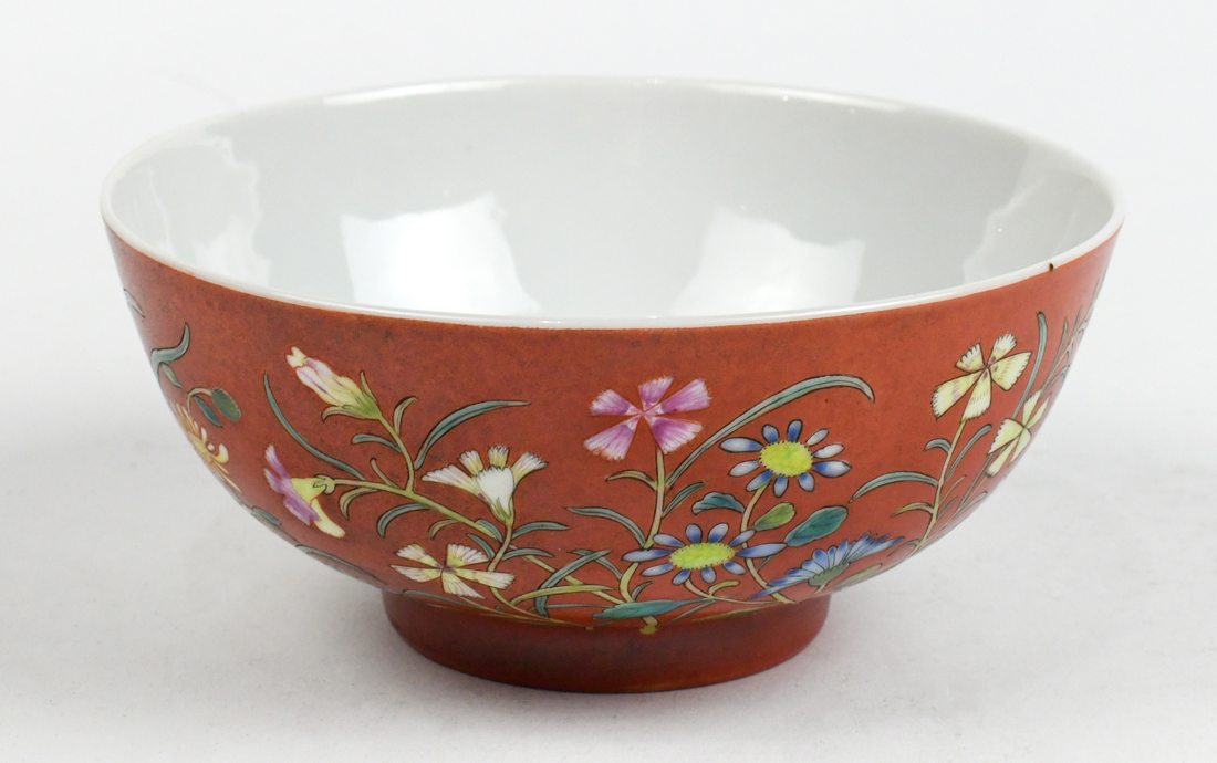 Chinese enameled porcelain bowl, featuring various flowers on an orange ground, base with apocryphal - Image 2 of 3