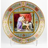 Royal Vienna porcelain partial gilt scenic charger, having a central scenic reserve depicting a well