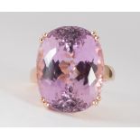 Kunzite and 14k rose gold ring Featuring (1) oval-cut kunzite, weighing approximately 31.20 cts.,