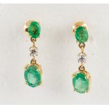 Pair of emerald, diamond and 14k yellow gold earrings Featuring (4) oval-cut emeralds, weighing a