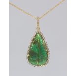 Emerald, diamond and 18k yellow gold pendant-necklace Featuring (1) pear-shaped emerald, cabochon,