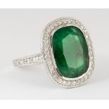 Emerald, diamond and 18k white gold ring Centering (1) cushion-cut emerald, weighing 11.73 cts.,