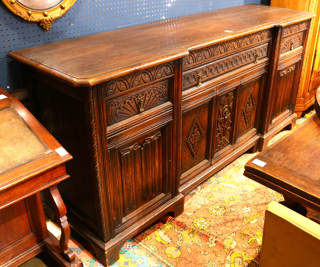 Continental Baroque style buffet circa 1890, having a carved oak case and rising on block feet, 39"h