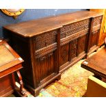 Continental Baroque style buffet circa 1890, having a carved oak case and rising on block feet, 39"h