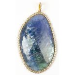 Tanzanite, diamond and 18k yellow gold pendant Featuring (1) irregular shaped tanzanite cabochon, 55