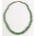 Jadeite bead and 9k rose gold necklace Comprised of (49) jadeite beads, ranging in size from