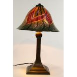 Lundberg Studios style table lamp, having a domed shade with pulled feather designs in purple, green