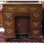 Federal style mahogany knee hole desk, the six drawers framing a single door cabinet, and rising