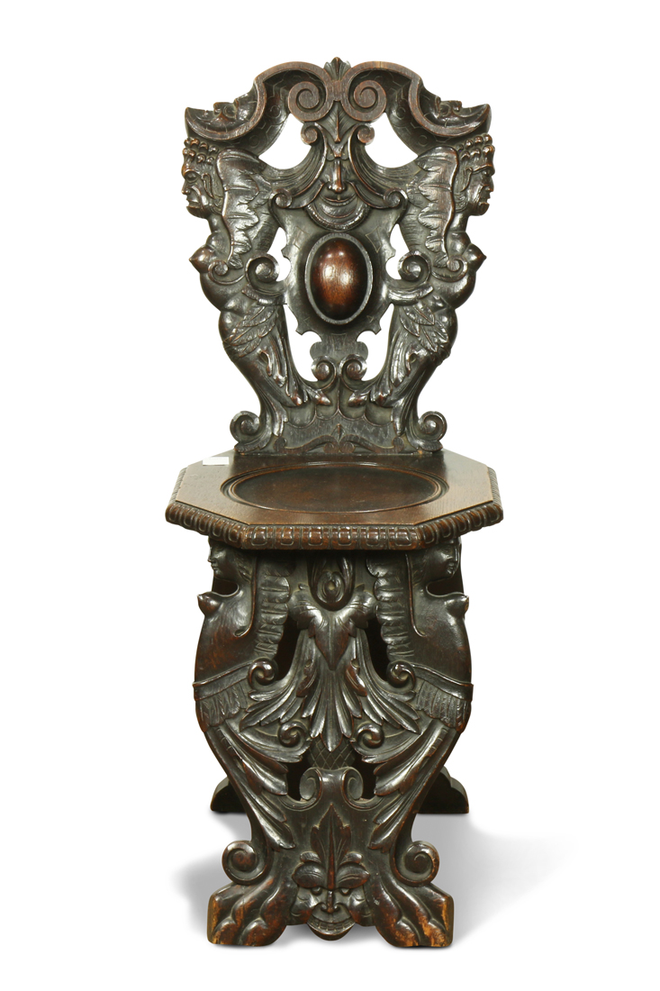 Baroque style carved oak side chair, the seat back decorated with stylized figures, above the