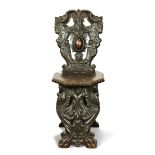 Baroque style carved oak side chair, the seat back decorated with stylized figures, above the