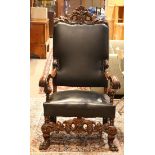 Jacobean style hall chair, having an acanthus decorated crest, above the black leather seat accented