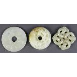 (lot of 3) Chinese hardstone bi-discs: one with fu-lions and brocade ball; one with shou medallions;