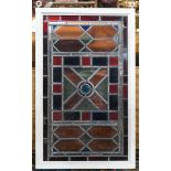 Victorian leaded glass panel, centered with a circular bullseye panel framed with geometric accents,