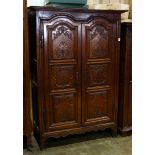 Louis XV style Provence, France, wedding armoire, having a molded top, above paneled doors, and