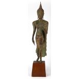 Thai bronze Buddha, Sukhothai style, in mid-step with left hand in abhaya mudra, on wood stand,