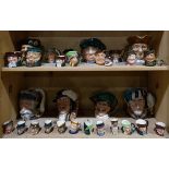 Two shelves of Royal Doulton character jugs, in various sizes including "Toby Philpotts," "Vicar