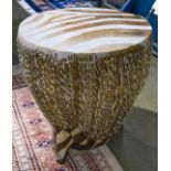 Ethnic style decorative drum or table, having a hide cover over wood with a tripod base, 20"h x 15"