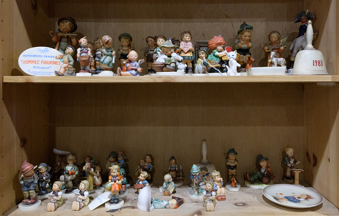 Two shelves of mostly Hummels including Playmates, Retreat to Safety, Singing Lesson, etc. Early