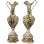 Large pair of Italian Capodimonte ewers, each having partial gilt accents with applied floral