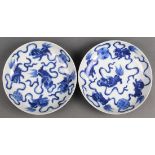 (lot of 2) Chinese underglazed blue porcelain dishes, each of five fu-lions playing with brocade