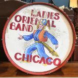Vintage bass drum, having an red frame, surrounding a inscription reading "Ladies Oriental Band,